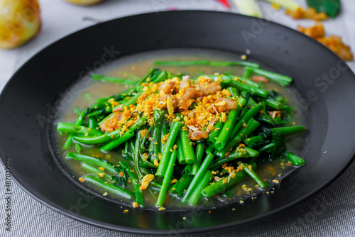 Stir-fried morning glory in a black dish "Stir-Fried Morning Glory" is also one of the most delicious dishes you can eat in Thailand.