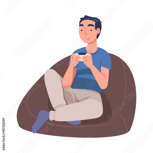Man Character with Gamepad as Digital Device Sitting in Armchair Suffering from Internet Addiction Vector Illustration