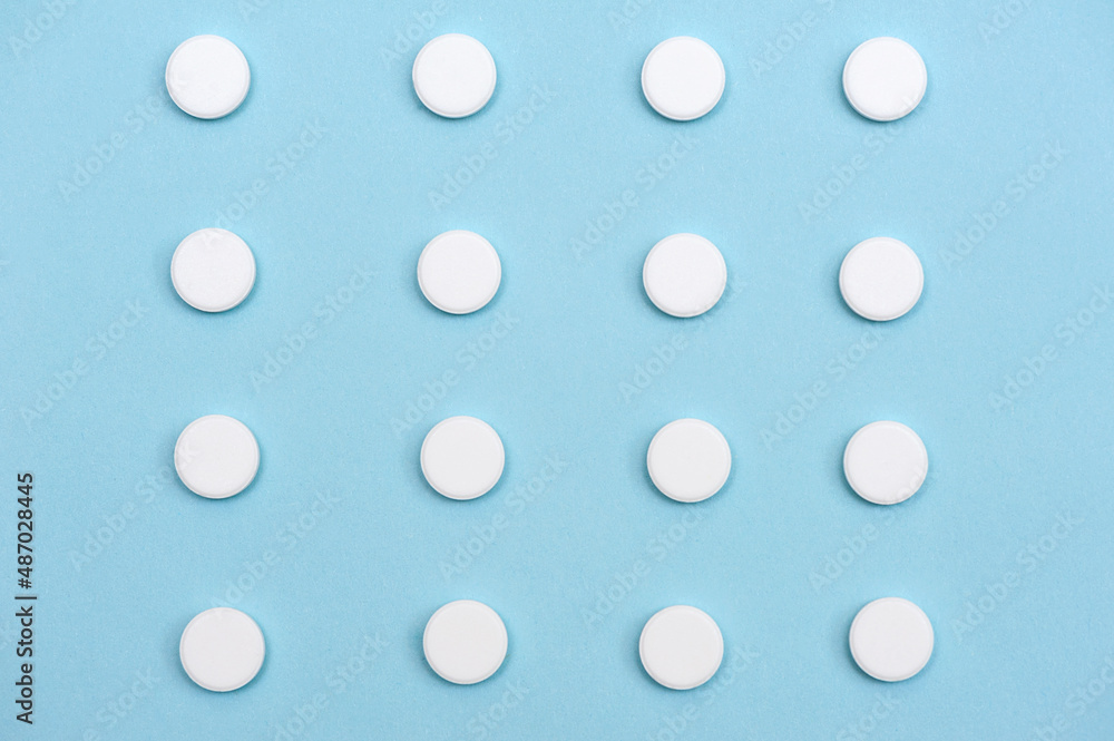 Repeating white pills on a blue background.