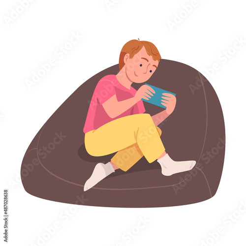 Teen Boy Character with Digital Device Sitting in Armchair Suffering from Internet Addiction Vector Illustration
