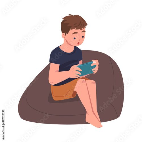 Teen Boy Character with Digital Device Sitting in Armchair Suffering from Internet Addiction Vector Illustration