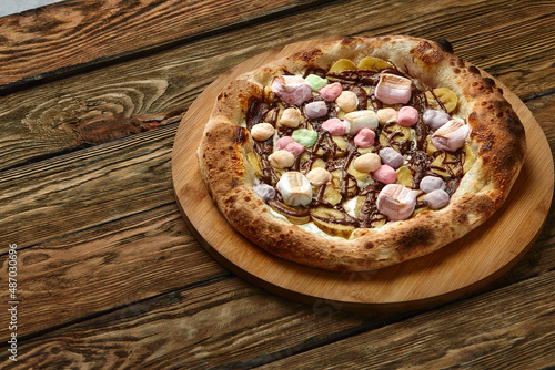 Whole sweet pizza served with marshmallows and candies