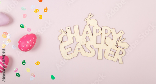 greeting card with text happy easter. multicolored easter eggs on pink background