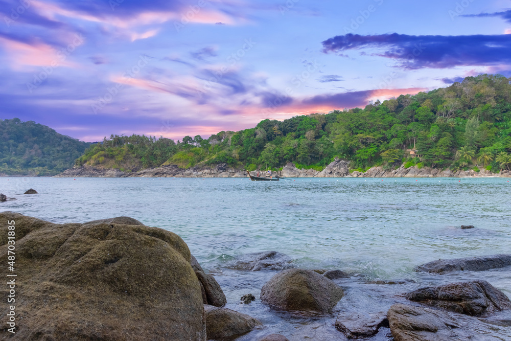 Fototapeta premium Long tail Boat on colourful sunset over a Beach in Phuket Thailand