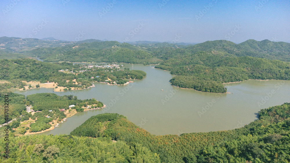 Area of Huai Krathing reservoir for Rafting and Eating at Loei Province, Thailand. Beautiful natural landscape of the river, mountain, blue sky with green forest and bamboo raft shelter.