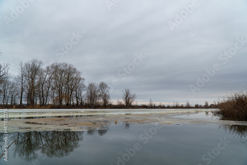 The spring Flood on the river on a cloudy day. Spring landscape.