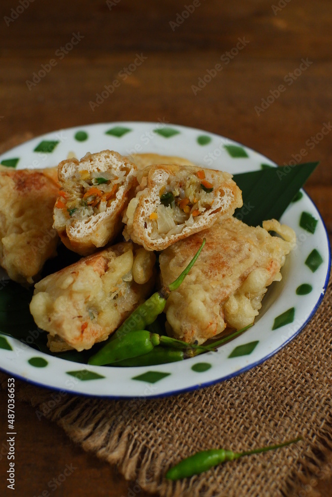 a plate of fried tofu filled with vegetables named tahu isi in Bahasa a plate of fried tofu filled with vegetables named tahu isi in Bahasa