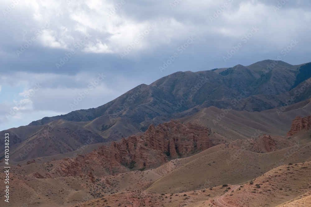 Beautiful red clay mountains eroded on wind. Red mountains or red canyon on the way from Assy plateau to Bartogai reservoir. Mountain canyon landscape.