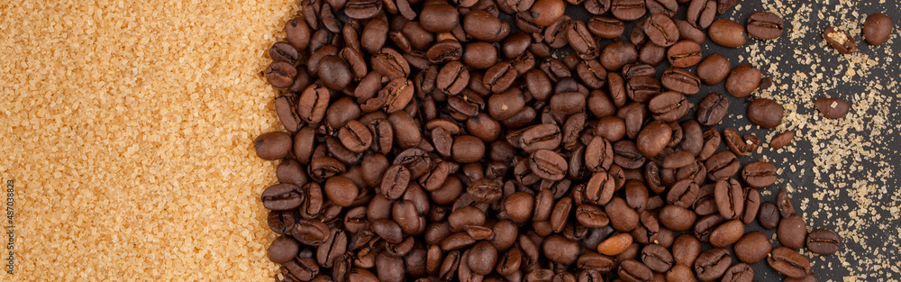 Scattered coffee beans and brown sugar on a black countertop. Scattered coffee beans and brown sugar on a black countertop.