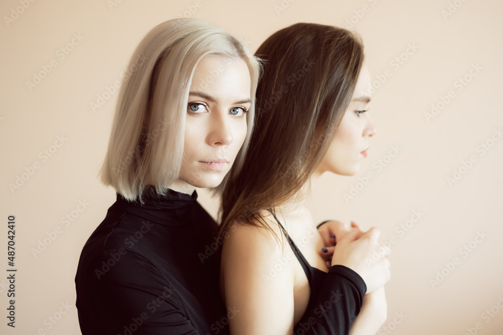 Top view of two young women on a light background. Top view of two young women on a light background.