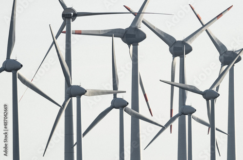 Wind turbines against sunny blue sky
 photo