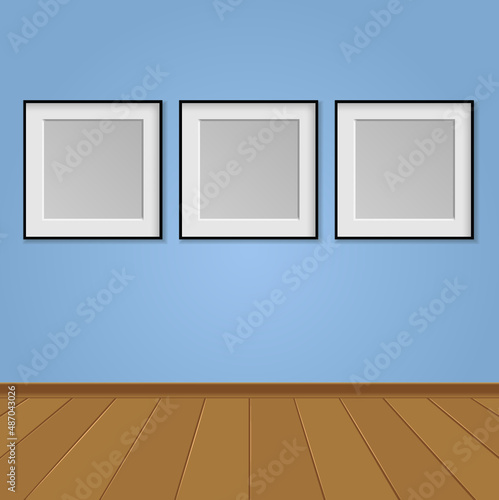 three poster frames on the blue wall in the gallery interior