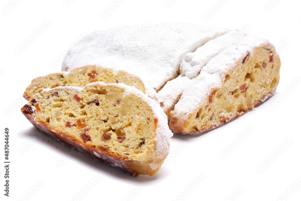 Sliced Traditional Christmas stollen cake with marzipan and dried fruit isolated on white background