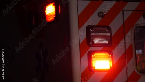 Flashing light from emergency Ambulance rainy stormy night