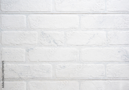 The modern texture of a white brick wall can be used as a background or a sample for a design.