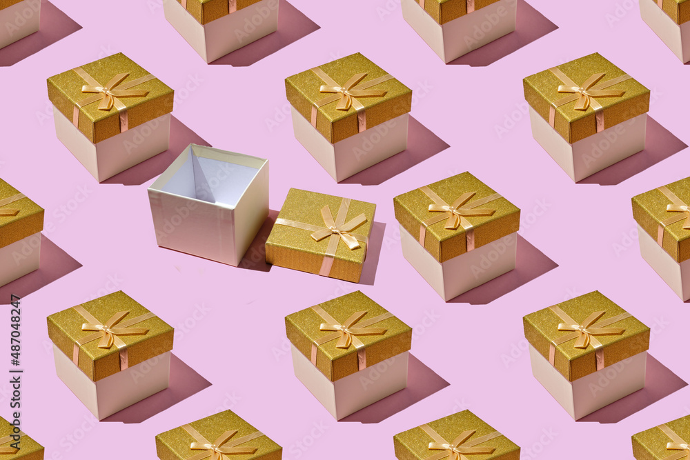 Gift box decorated with golden bow. composition made from gift box, on trendy pink background. Flat lay, top view.