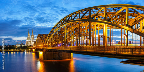 Cologne Cathedral city skyline and Hohenzollern bridge with Rhine river in Germany at twilight panorama photo