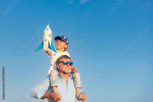 Grandfather and boy having fun outdoor