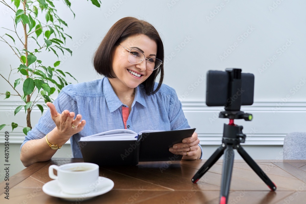 Woman teacher, mentor, psychologist looking at webcam of smartphone, talking, counseling Woman teacher, mentor, psychologist looking at webcam of smartphone, talking, counseling