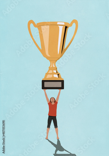 Victorious woman holding large trophy overhead

