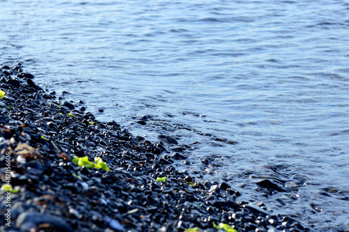 Beautiful romantic photo, seashore on the beach. Relaxing seascape. Waves with foam on the sea. Summer sunny day. Vacation spirit. Beautiful landscape. Nature background.
