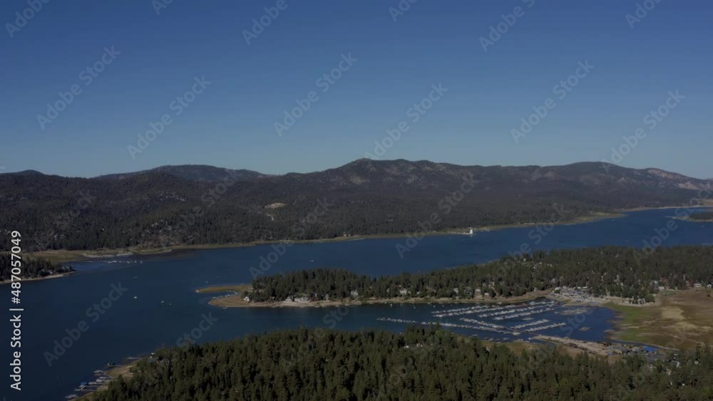 A stunning drone shot at high altitude flying towards the Big Bear Lake with a view over the Marina in San Bernardino County, California. A stunning drone shot at high altitude flying towards the Big Bear Lake with a view over the Marina in San Bernardino County, California.