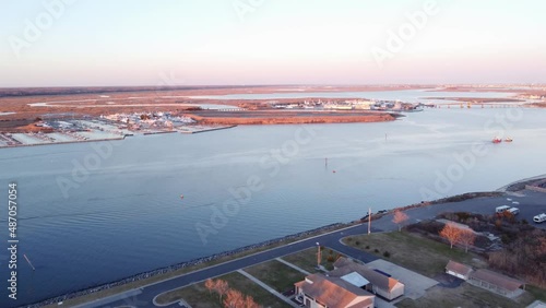 Aerial drone shot, flying over crystal clear water towards a marina in Cape May New Jersey, Cape May County. photo