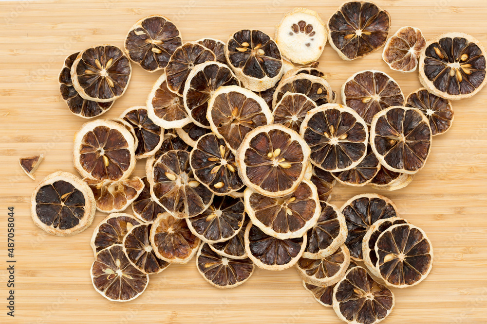 dried lemon slices on a wooden background dried lemon slices on a wooden background