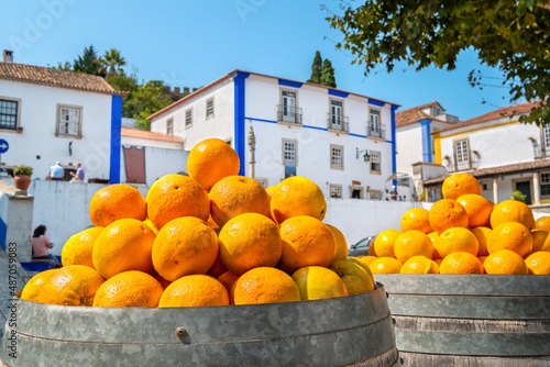 Barrels with oranges. Obidos, Portugal