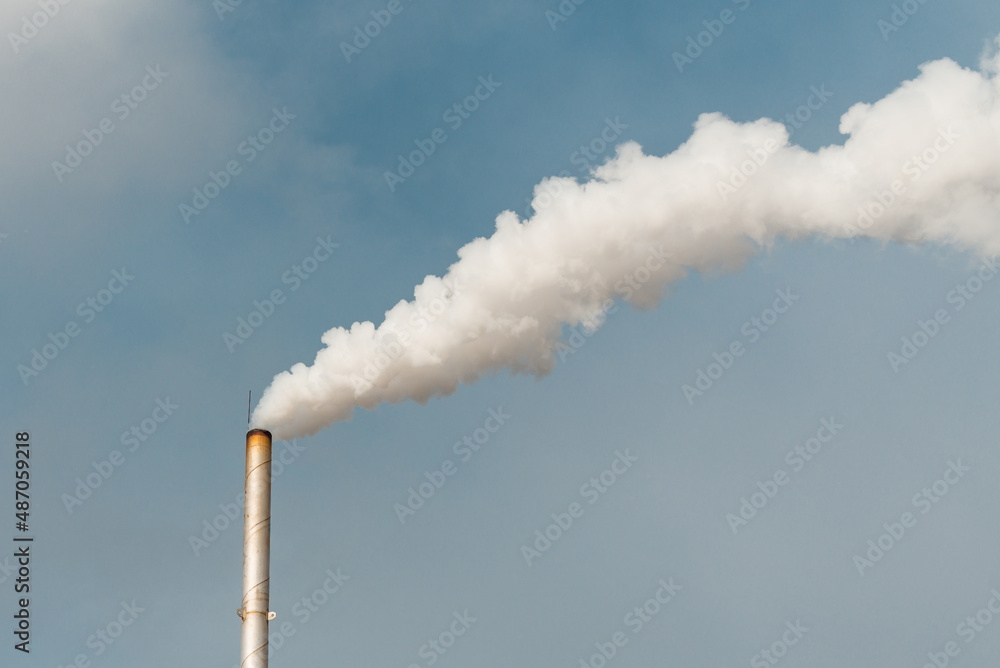 Pipe and smoke.Polluting air with white smoke from industrial chimney outdoors. CO2 emissions.Copy space. Pipe and smoke.Polluting air with white smoke from industrial chimney outdoors. CO2 emissions.Copy space.