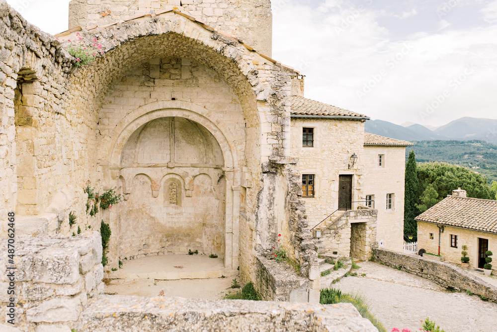 Arch of a castle ruin on the top of the old village Le-Poët-Laval in the south of France in the Drôme