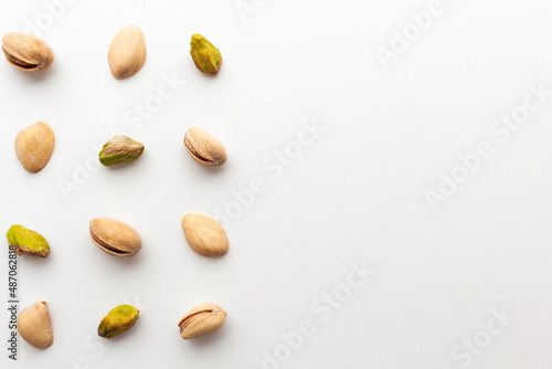 Pattern of roasted pistachios isolated on white background.