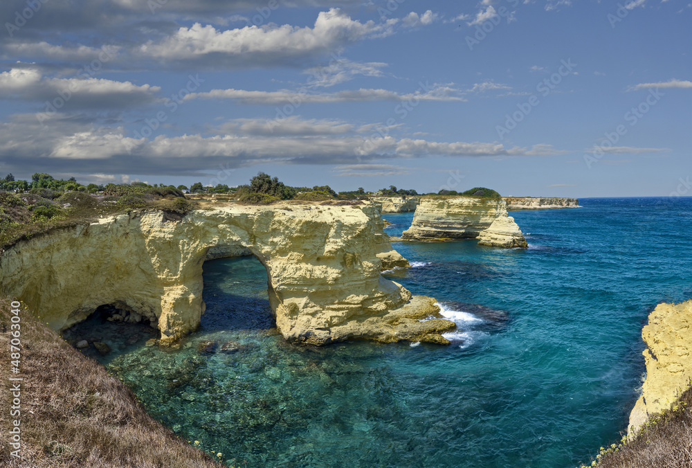 Melendugno, province of Lecce, Puglia, Italy. August 2021. The stacks of Sant'Andrea are a point of naturalistic attraction: large panoramic photos of the amazing landscape.