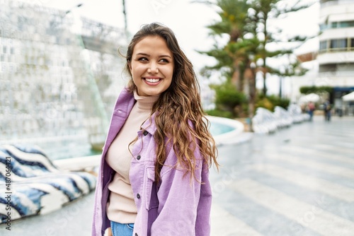 young hispanic girl smiling happy standing at the city.