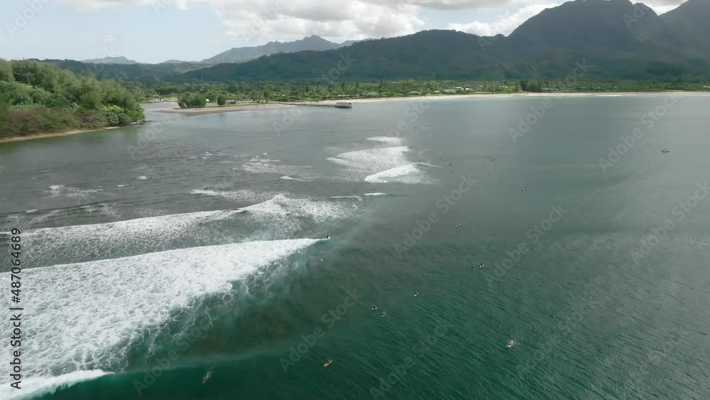 crowds of surfers on the shorebreak of Hanalei Bay, Kauai island in Hawaii. Aerial view crowds of surfers on the shorebreak of Hanalei Bay, Kauai island in Hawaii. Aerial view