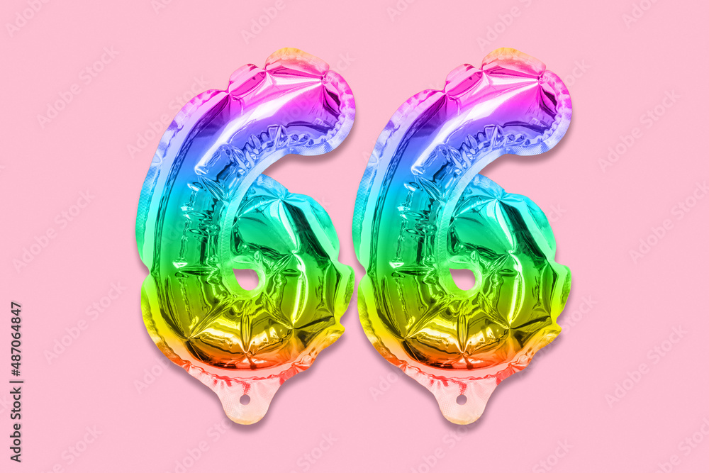 Rainbow foil balloon number, digit sixty six on a pink background. Birthday greeting card with inscription 66. Anniversary concept. Top view. Numerical digit. Celebration event, template.