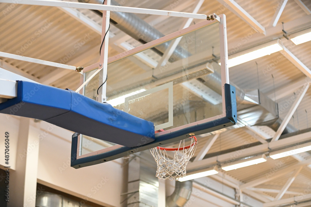 Fototapeta premium Basketball hoop close up in old school sport gym hall