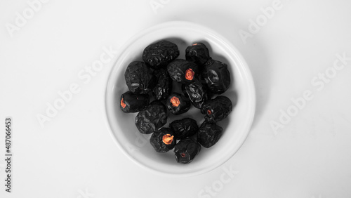 a plate of ajwa dates in a white background