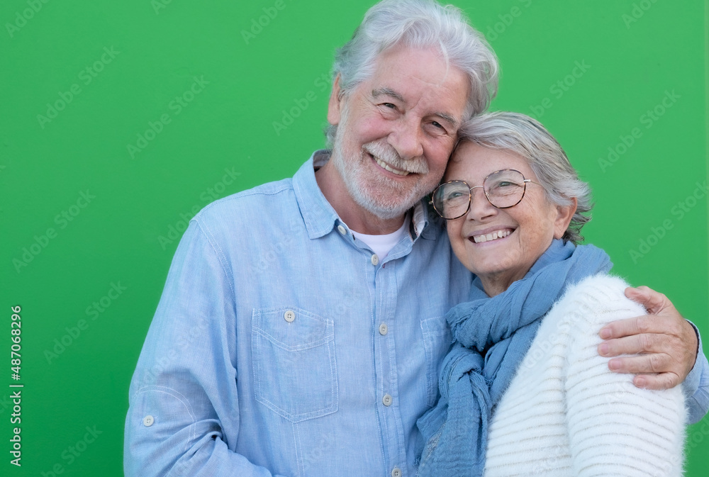 Happy Elderly adult mature couple in love. Senior husband and wife hugging and bonding with true emotions. Carefree cheerful old bearded husband embracing his wife looking at camera enjoying wellbeing Happy Elderly adult mature couple in love. Senior husband and wife hugging and bonding with true emotions. Carefree cheerful old bearded husband embracing his wife looking at camera enjoying wellbeing