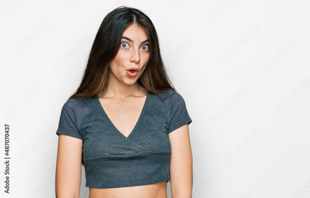 Young beautiful teen girl wearing casual crop top t shirt afraid and shocked with surprise expression, fear and excited face. Young beautiful teen girl wearing casual crop top t shirt afraid and shocked with surprise expression, fear and excited face.