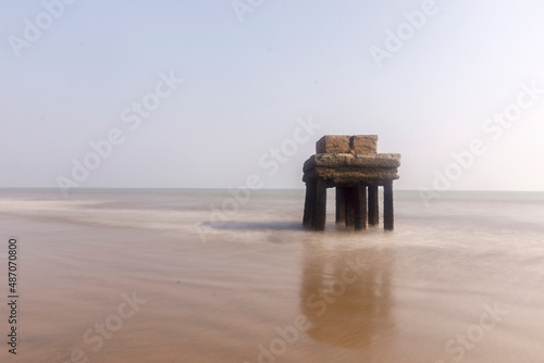 Black and white long exposure photo of a very old architectural structure on sea beach at Digha, West Bengal. photo