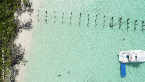 AERIAL - Boat on clear turquoise waters, Cayo Icacos, Puerto Rico, top down rising photo