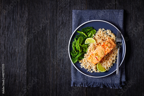 portion of cooked Salmon with rice and greens