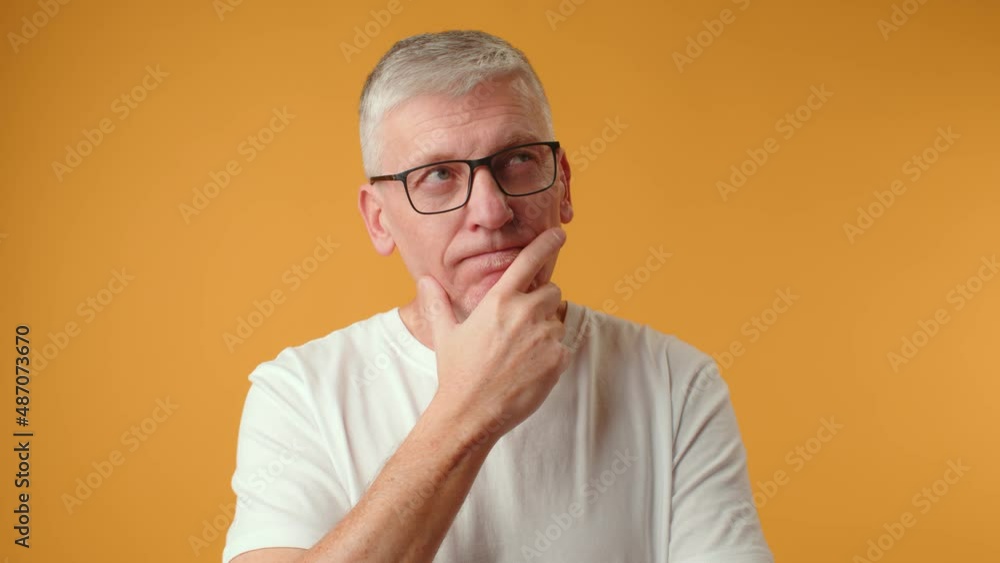 Middle age handsome grey-haired man thinking about question, doubtful expression Middle age handsome grey-haired man thinking about question, doubtful expression