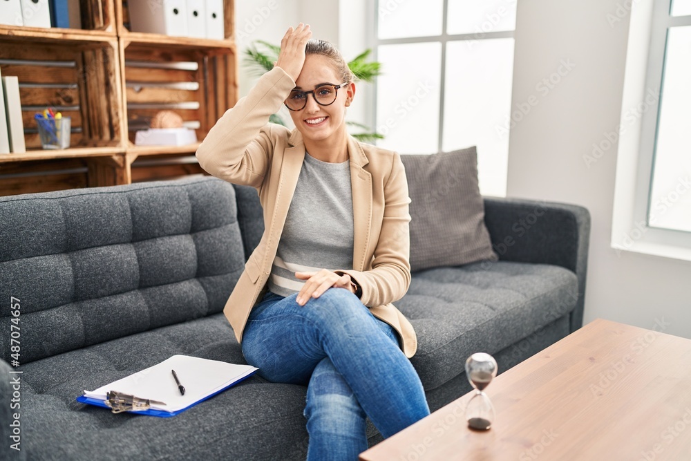 Young woman working at consultation office surprised with hand on head for mistake, remember error. forgot, bad memory concept. Young woman working at consultation office surprised with hand on head for mistake, remember error. forgot, bad memory concept.