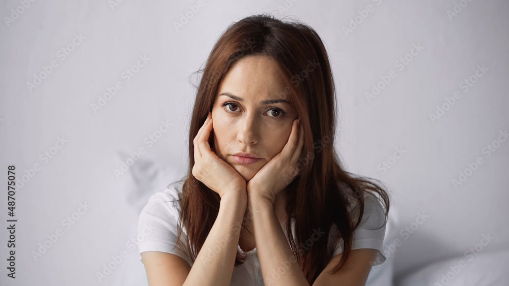offended woman with hands near face looking at camera at home offended woman with hands near face looking at camera at home
