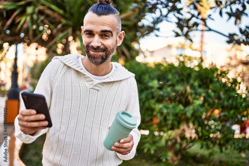 Handsome middle age man with beard standing happy and confident outdoors using smartphone Handsome middle age man with beard standing happy and confident outdoors using smartphone