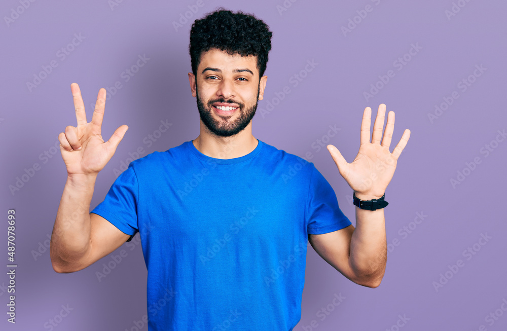 Young arab man with beard wearing casual blue t shirt showing and pointing up with fingers number eight while smiling confident and happy. Young arab man with beard wearing casual blue t shirt showing and pointing up with fingers number eight while smiling confident and happy.