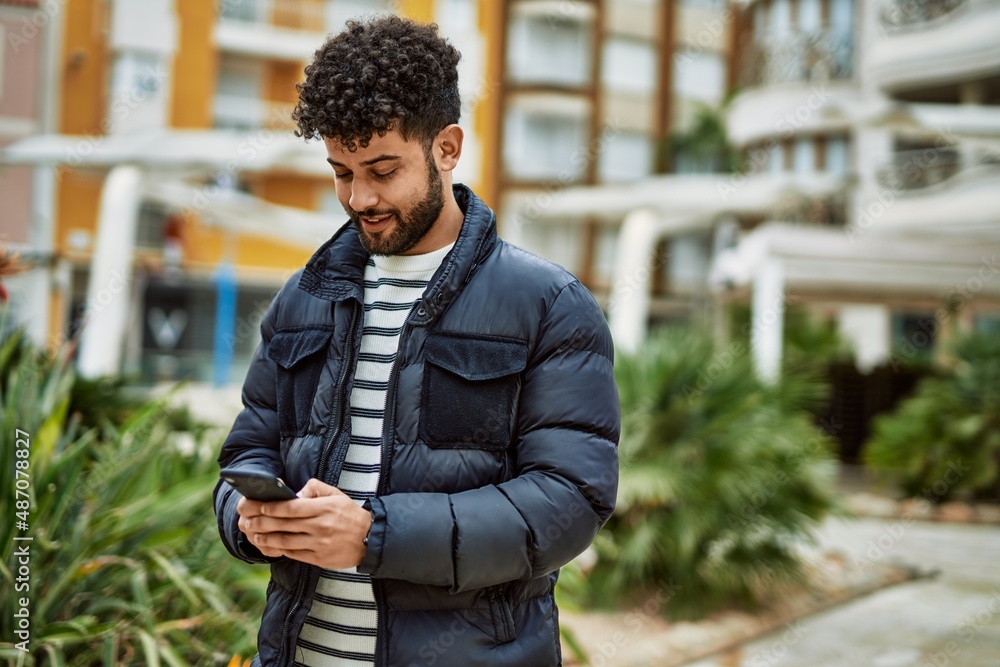 Young arab man using smartphone outdoor at the town Young arab man using smartphone outdoor at the town