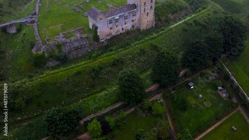 Drone pan of medieval Helmsley Castle, town and walled garden at dusk photo